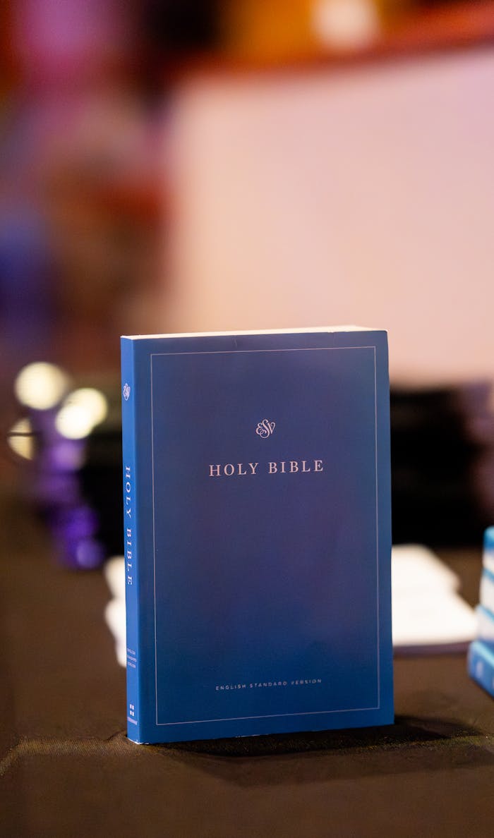 Blue Holy Bible on a table, perfect for religious themes and concepts.